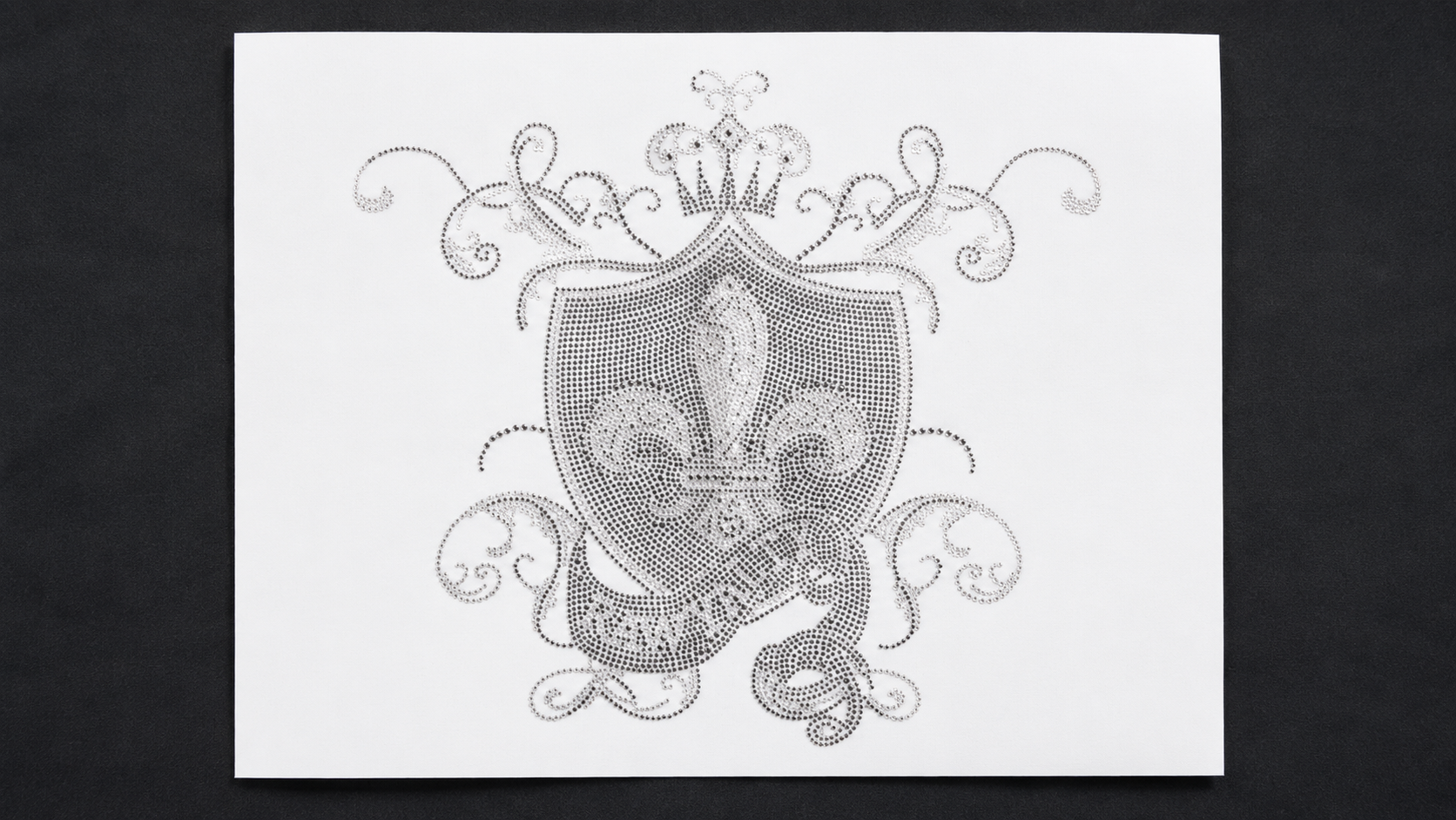 Silver rhinestone ornamental crest with crown and fleur-de-lis details on a transfer sheet